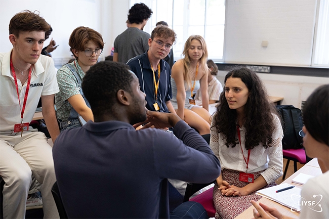 Teens collaborating on a robotics project at a STEM camp.