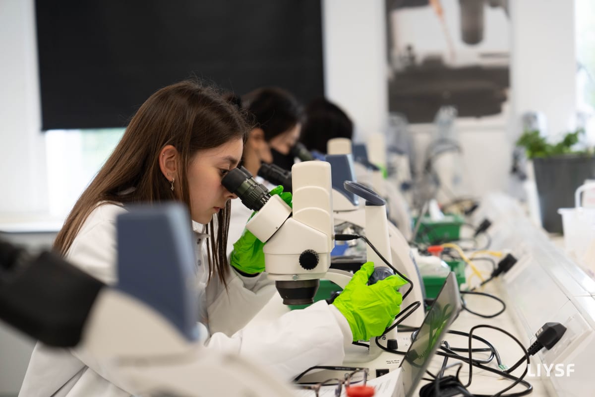 LIYSF student conducting scientific research using a microscope during a laboratory session in London